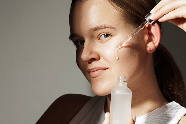 woman applying retinol cream at night showing correct evening skincare routine