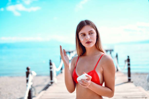 Cute Female And Her Favorite Sunscreen to avoid How to Get a Dark Tan Fast: What Actually Works