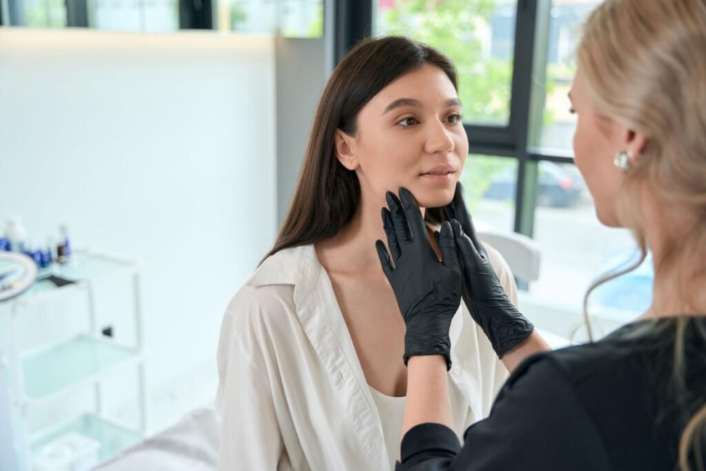 Dermatologist examining facial skin and planning treatment for rosacea