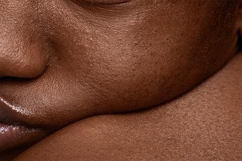 Healthy glowing dark skin protected with daily sunscreen