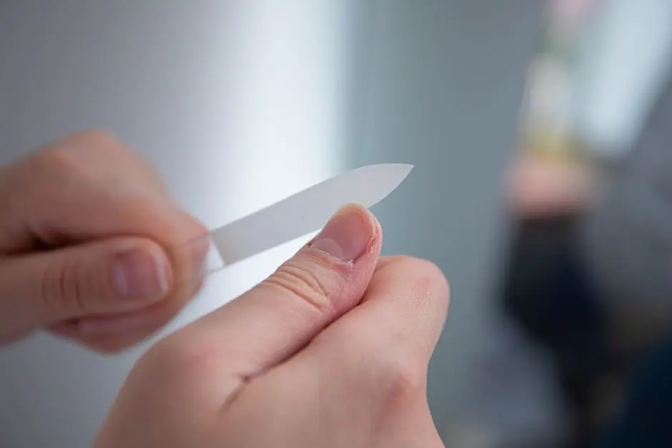 Detailed close-up of a person's hands filing nails with a nail file indoors. Top-Best Rated Magnesium Supplements of 2026
