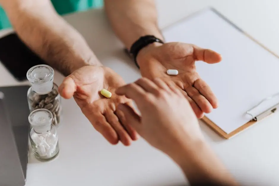 From above crop unrecognizable medical worker letting to chose patient remedy from illness
